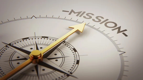 A wooden dart hitting the center of a target with the word Mission on it.